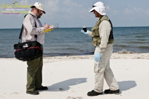 8/9/10 lat 30,14.5535N, long  88,43.3291W, Sampling with Boston Chemical Data, www.labs.pro , Pictured here is Strongbear and Jim Stiles collecting and documenting  weathered tar ball samples, south side of Horn Island.