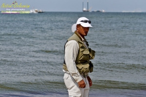 8/9/10 Horn Island, Lat  30,14.91N Long 88,42.0947W, Sampling with Boston Chemical Data, www.labs.pro , Pictured here is Strongbear  looking along beach for weathered tar ball samples from BP spill, north side of Horn Island.